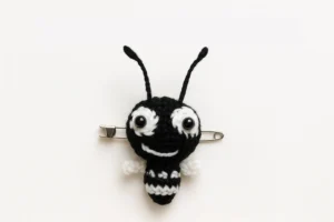 Crochet Ant Easy Amigurumi Keychain (Free Pattern) Crochet Ant Easy Amigurumi Keychain brooch version with asymmetric eyes and tiny wings on a safety pin