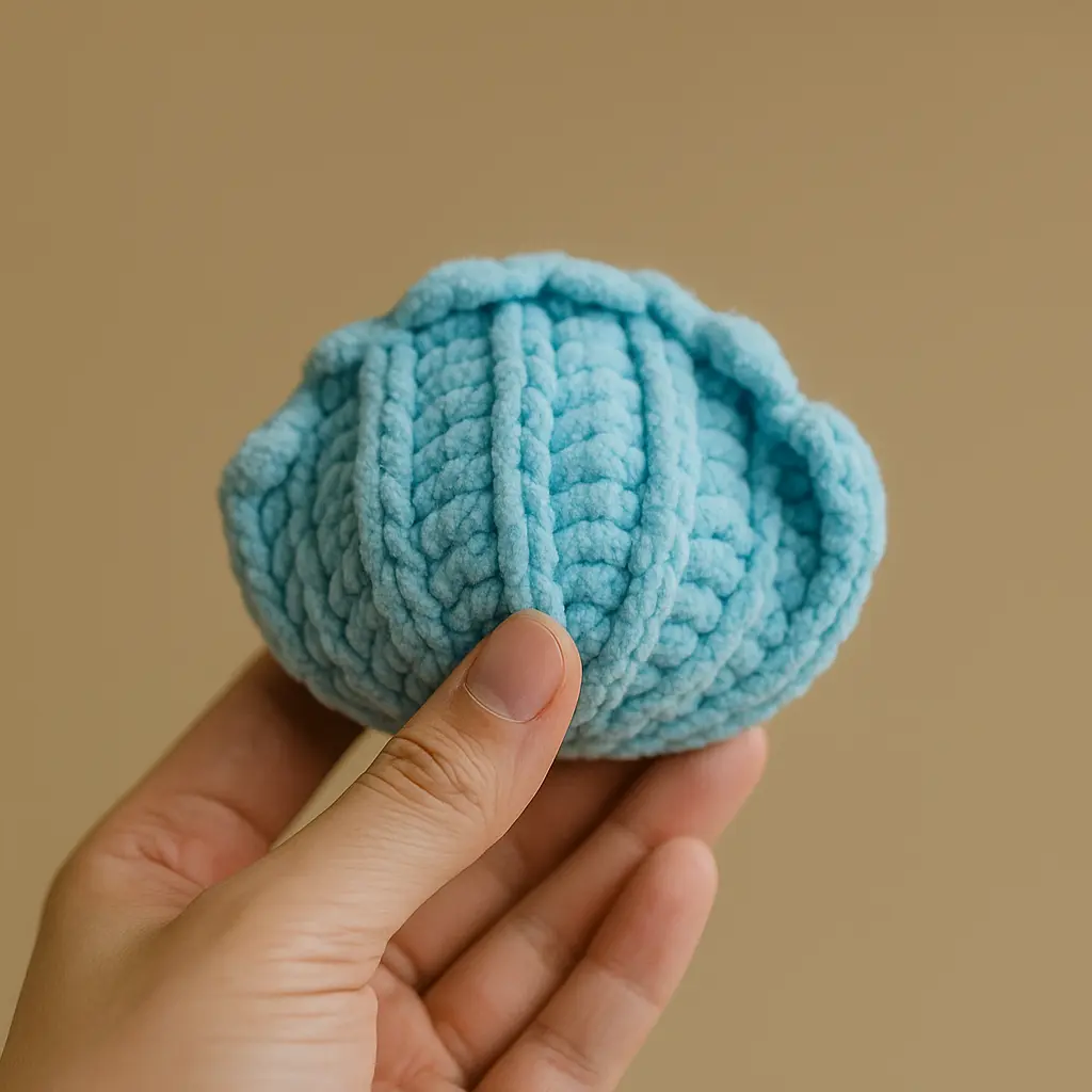 Textured blue crochet clam shell pattern with raised ridges