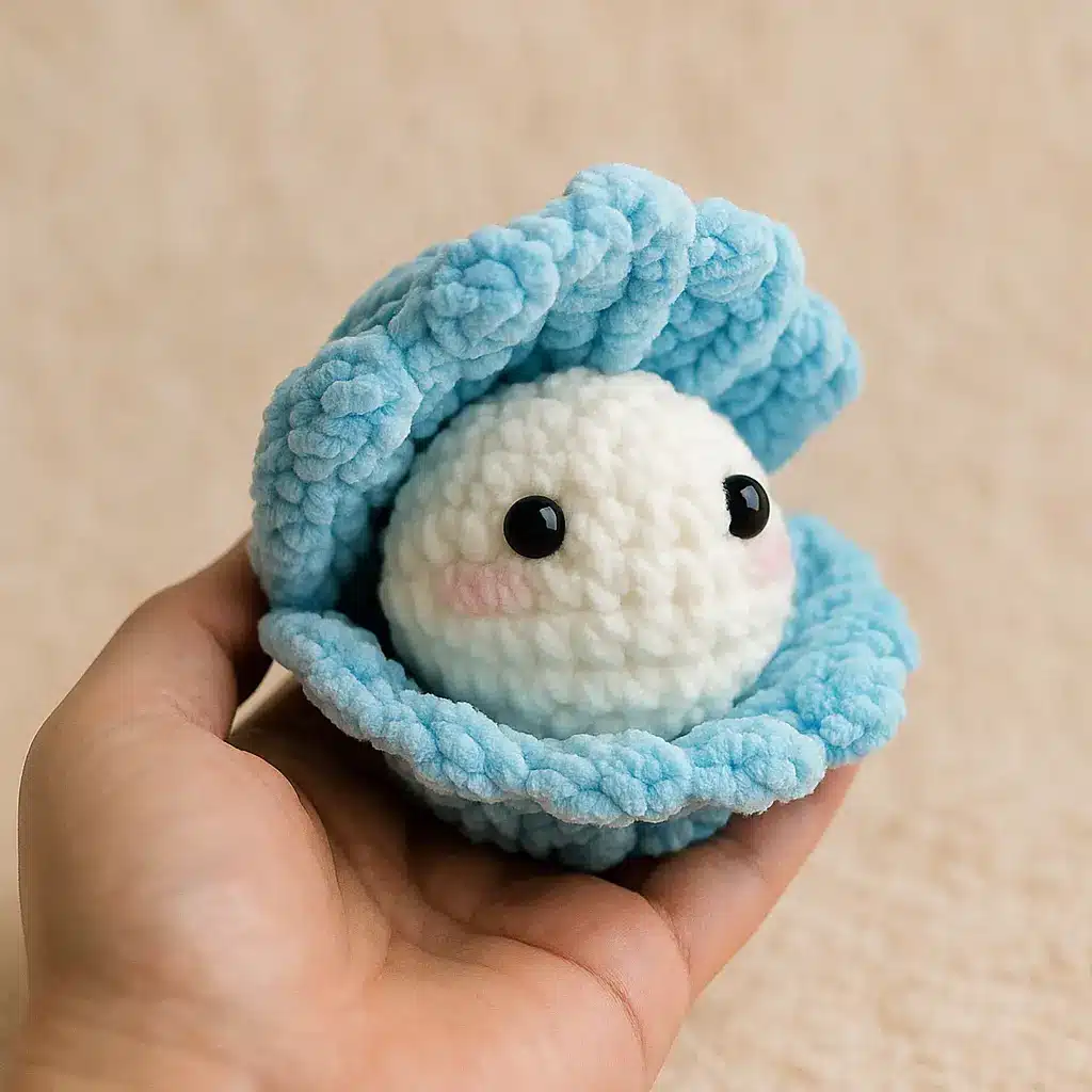 Finished crochet clam shell pattern with open blue shell and pearl inside