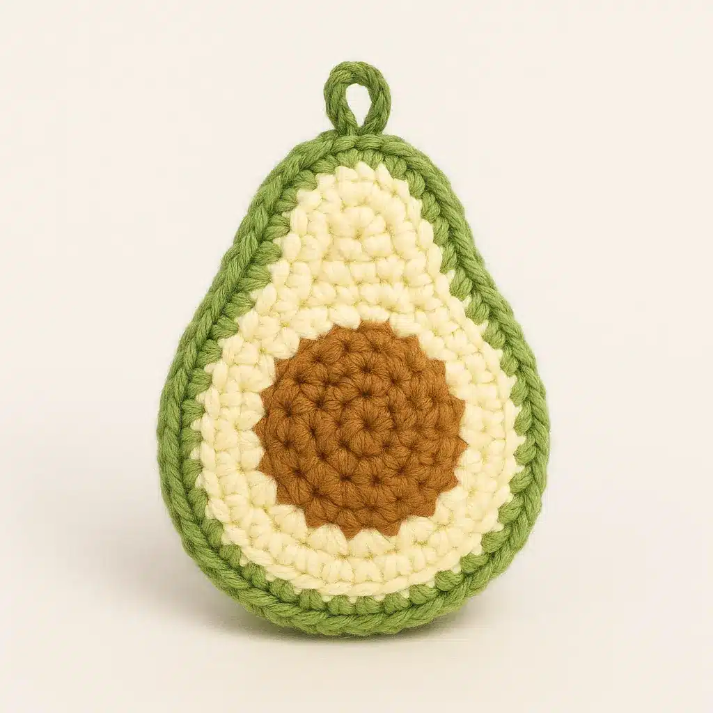 Back view of finished avocado crochet keychain with green peel and hanging loop.