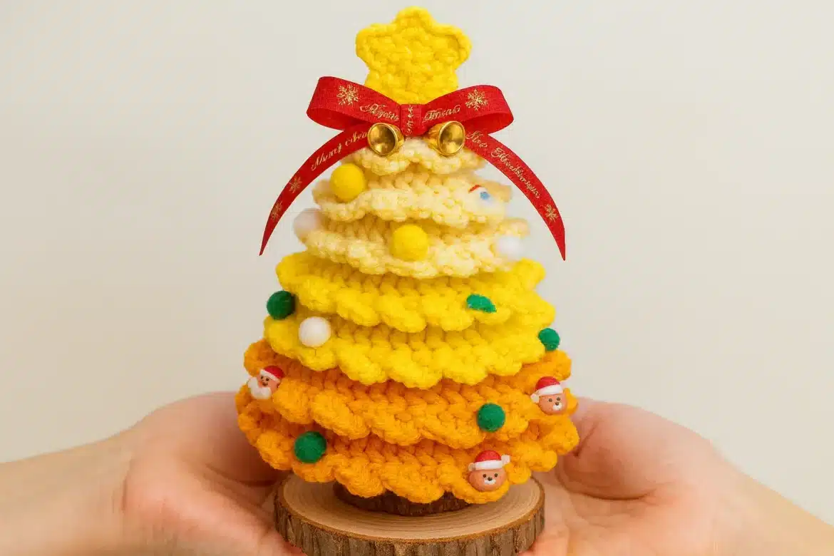 Rainbow ruffle crochet Christmas tree in yellow and orange held in hands