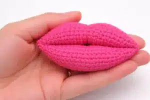 Angled view of the finished puffy crochet lips showing the lip line and curved shape – crochet lips pattern for valentine.