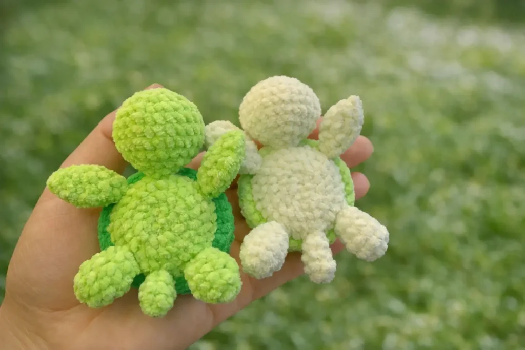 Mini sea turtle pattern crochet plush showing top shell and underside in green velvet yarn