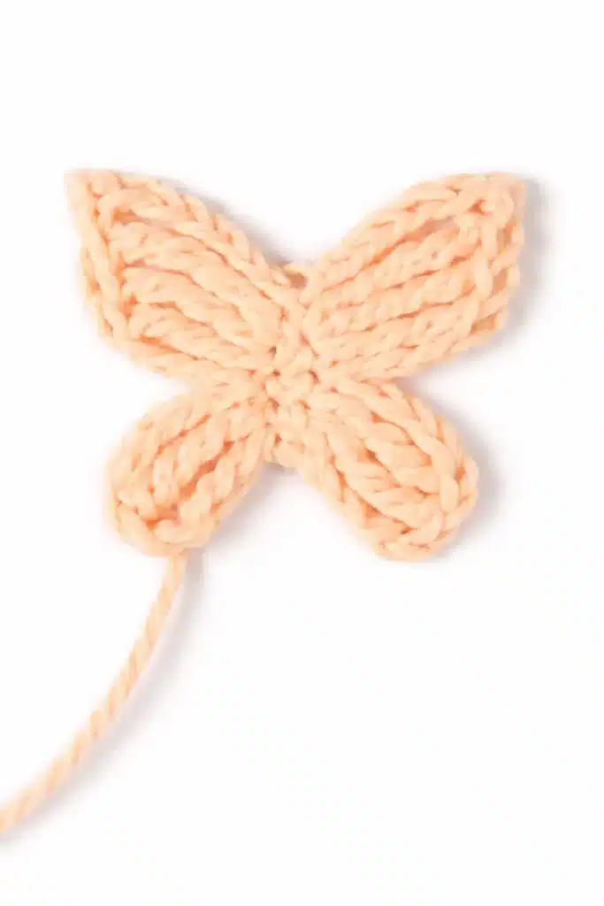 Step 1 butterfly motif for the Butterfly Granny Square Pattern in soft peach yarn