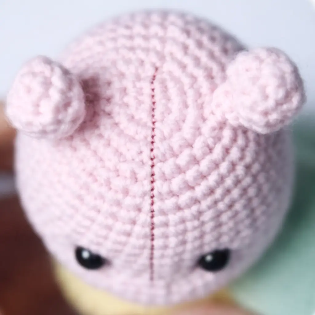 Antennae step for pastel caterpillar crochet pattern showing pink crochet antenna pieces