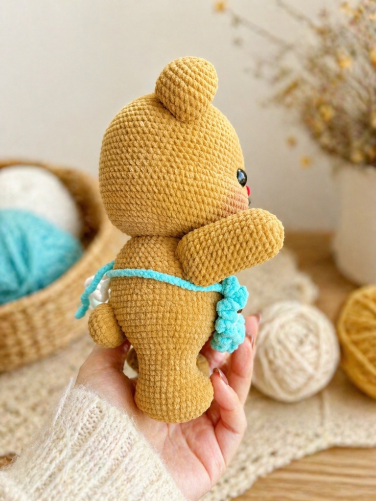 Mini butter bear crochet pattern side view showing apron tie and rounded body