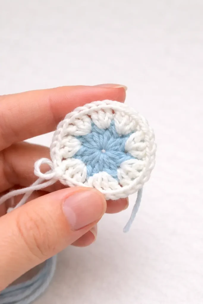 Pastel floral granny square crochet pattern with white petal round in progress