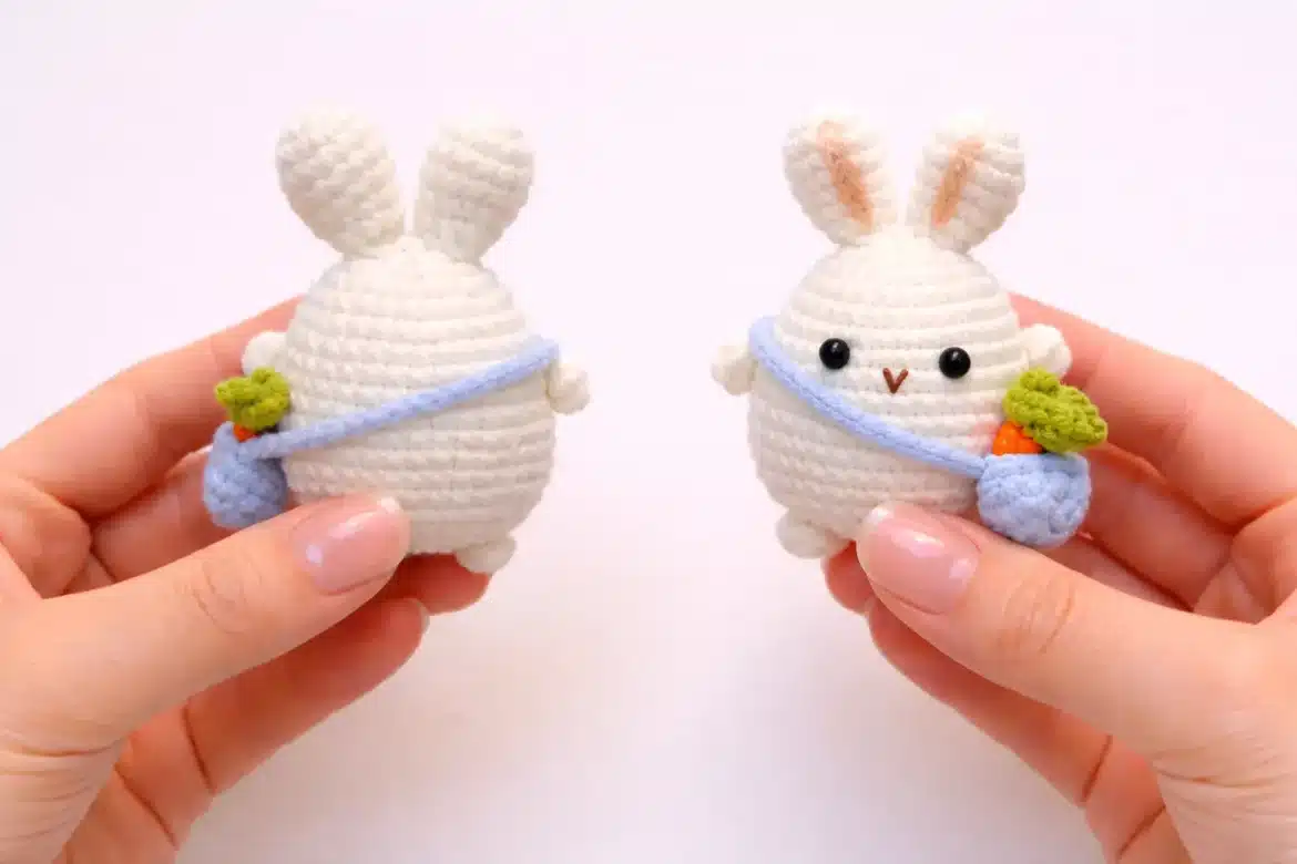 Mini bunny with carrot bag crochet pattern shown in front and back views while held in hands