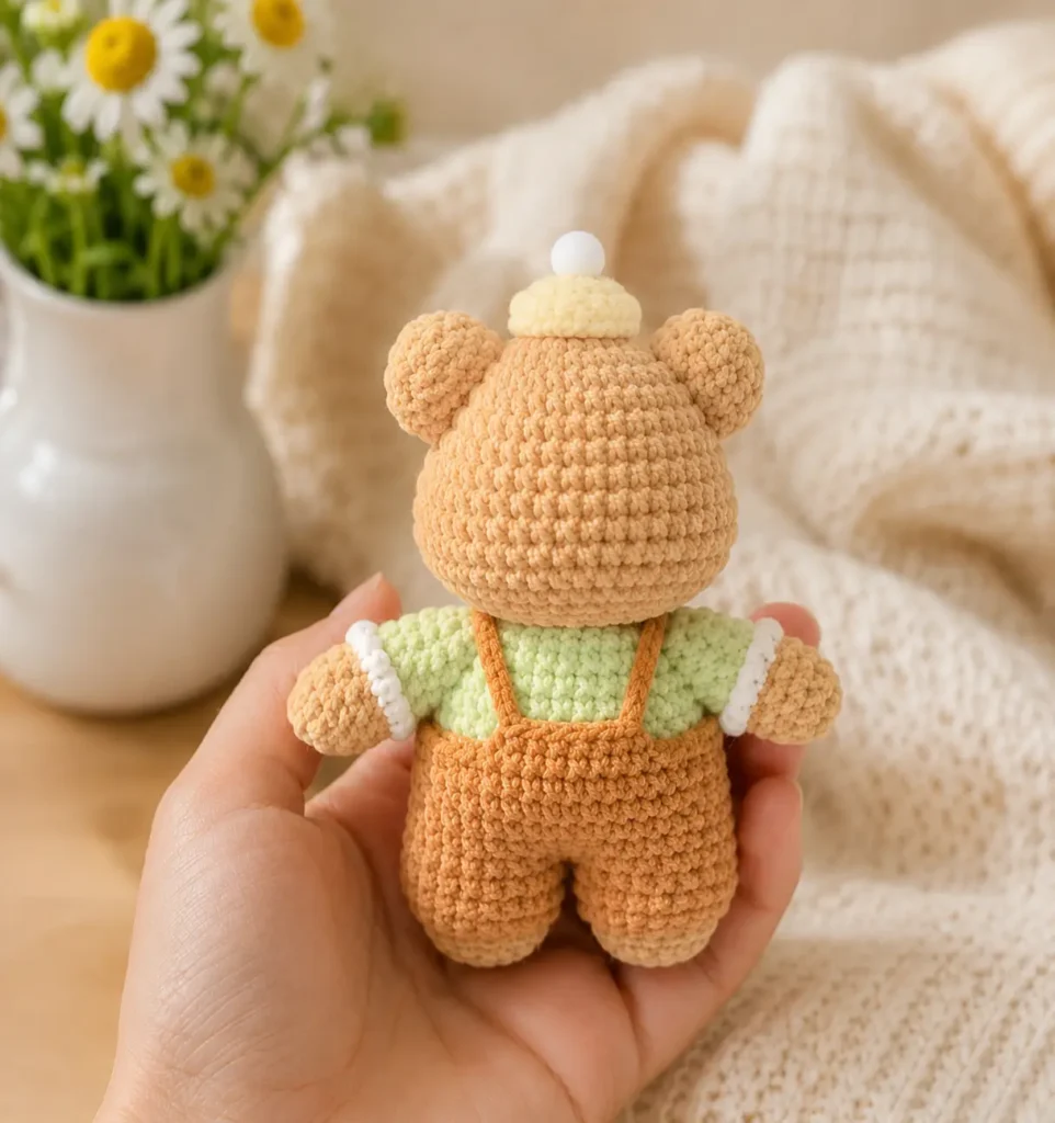 Cute Baby Bear Crochet Pattern back view showing orange overalls and straps